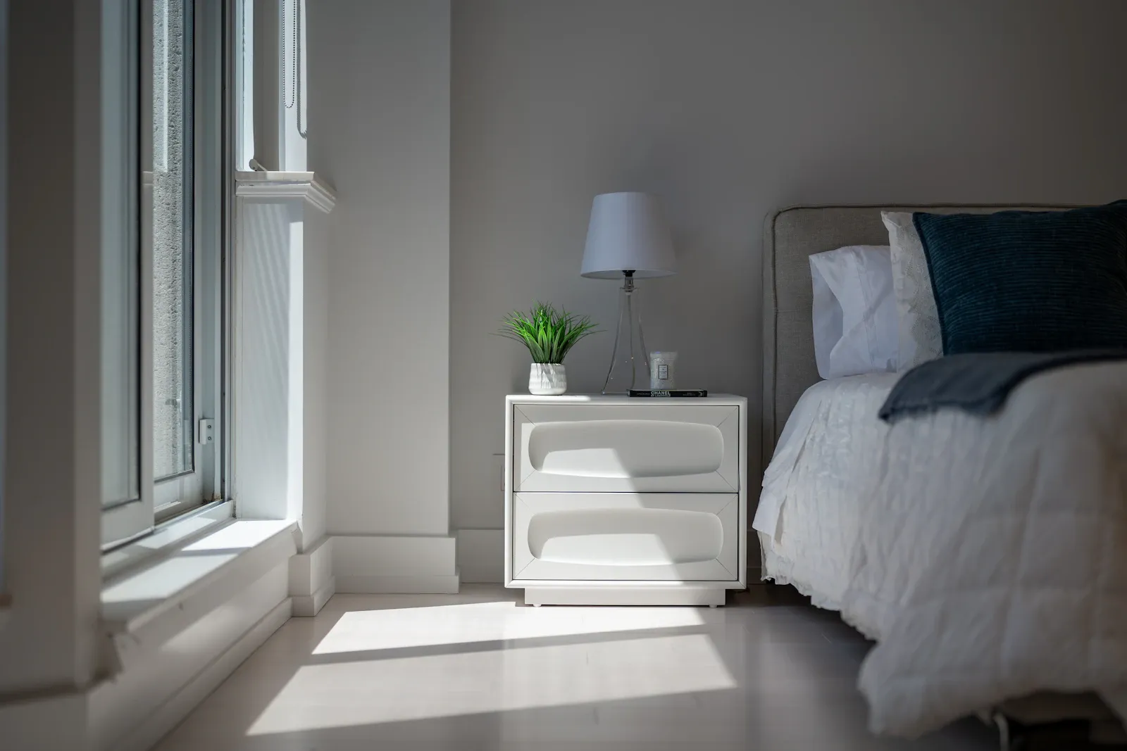 A softly lit bedroom with layered natural textures