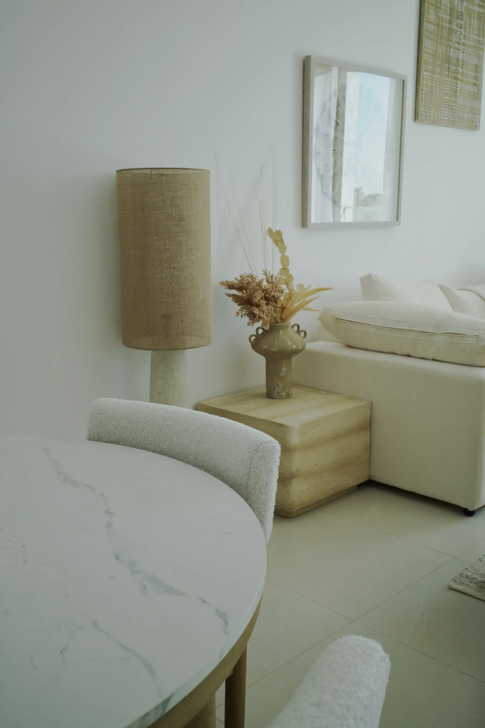 A light-filled living room with neutral tones and considered decor